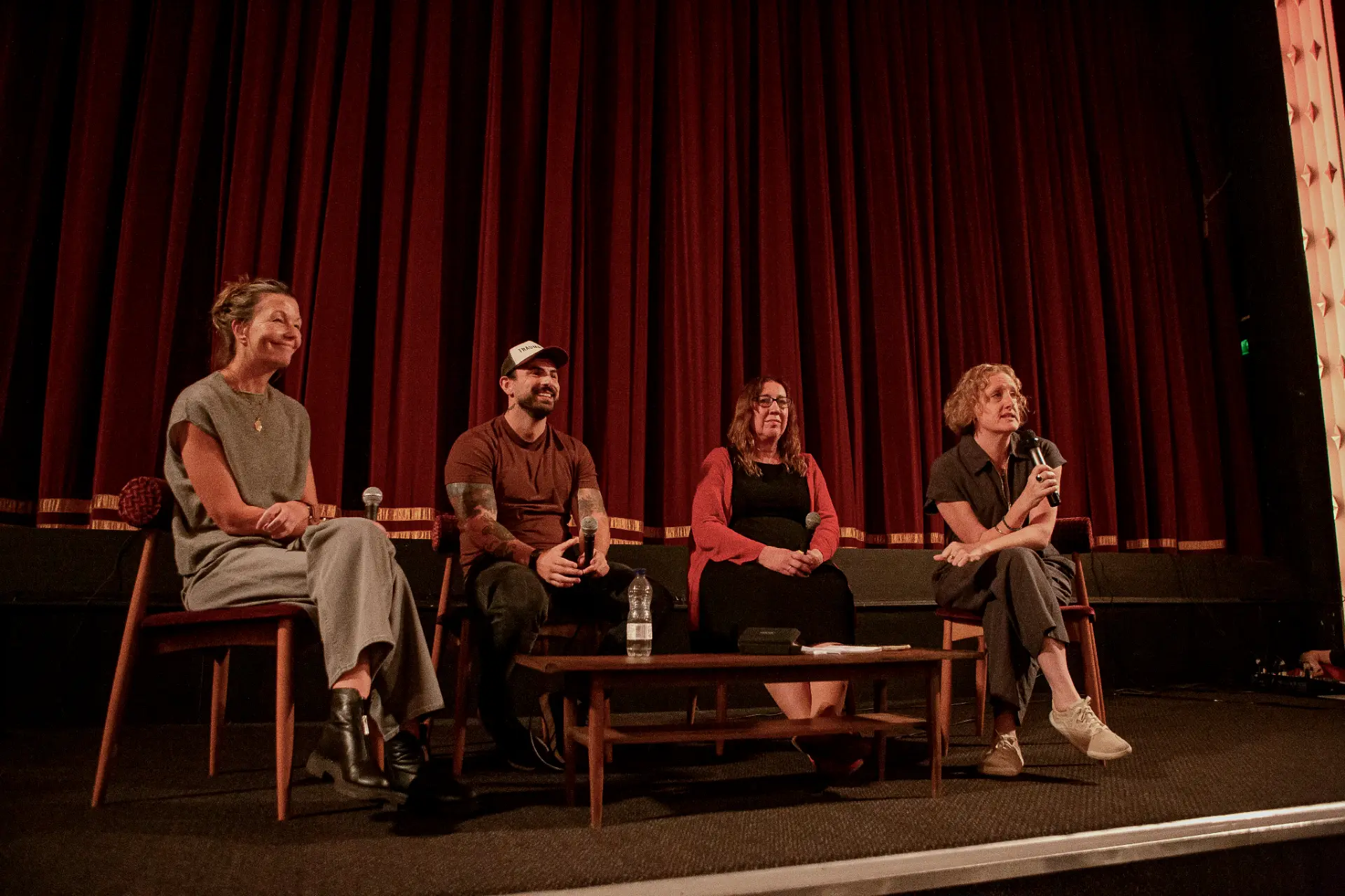 The TRAUMALITY panel on stage at the Duke of York's Picturehouse in Brighton, in front of red velvet curtains